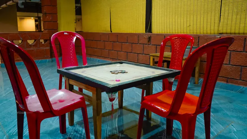 A chess table with red chairs